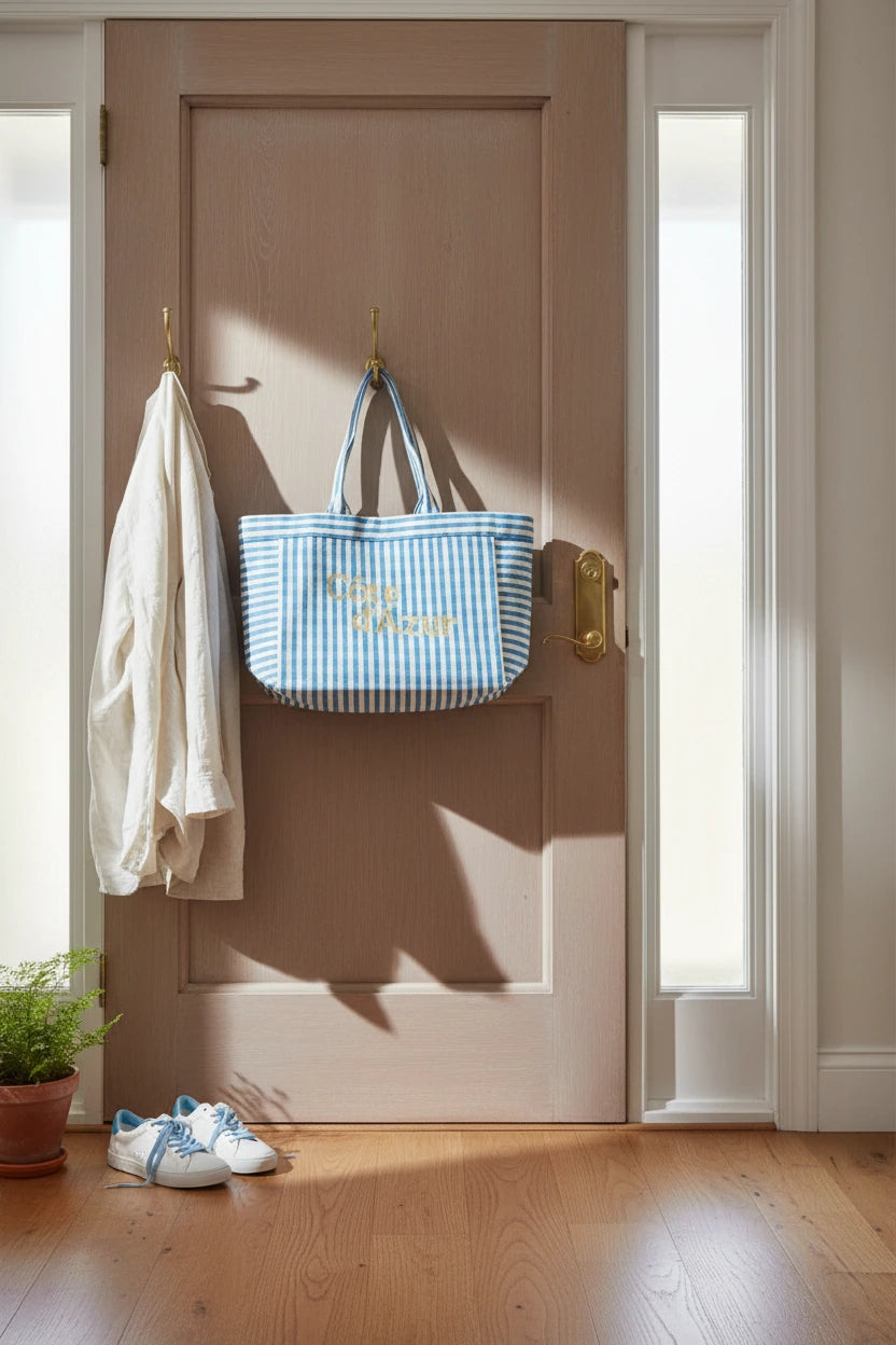 Blue and white striped tote bag with 'Cète d'Azur' text in gold embroidery