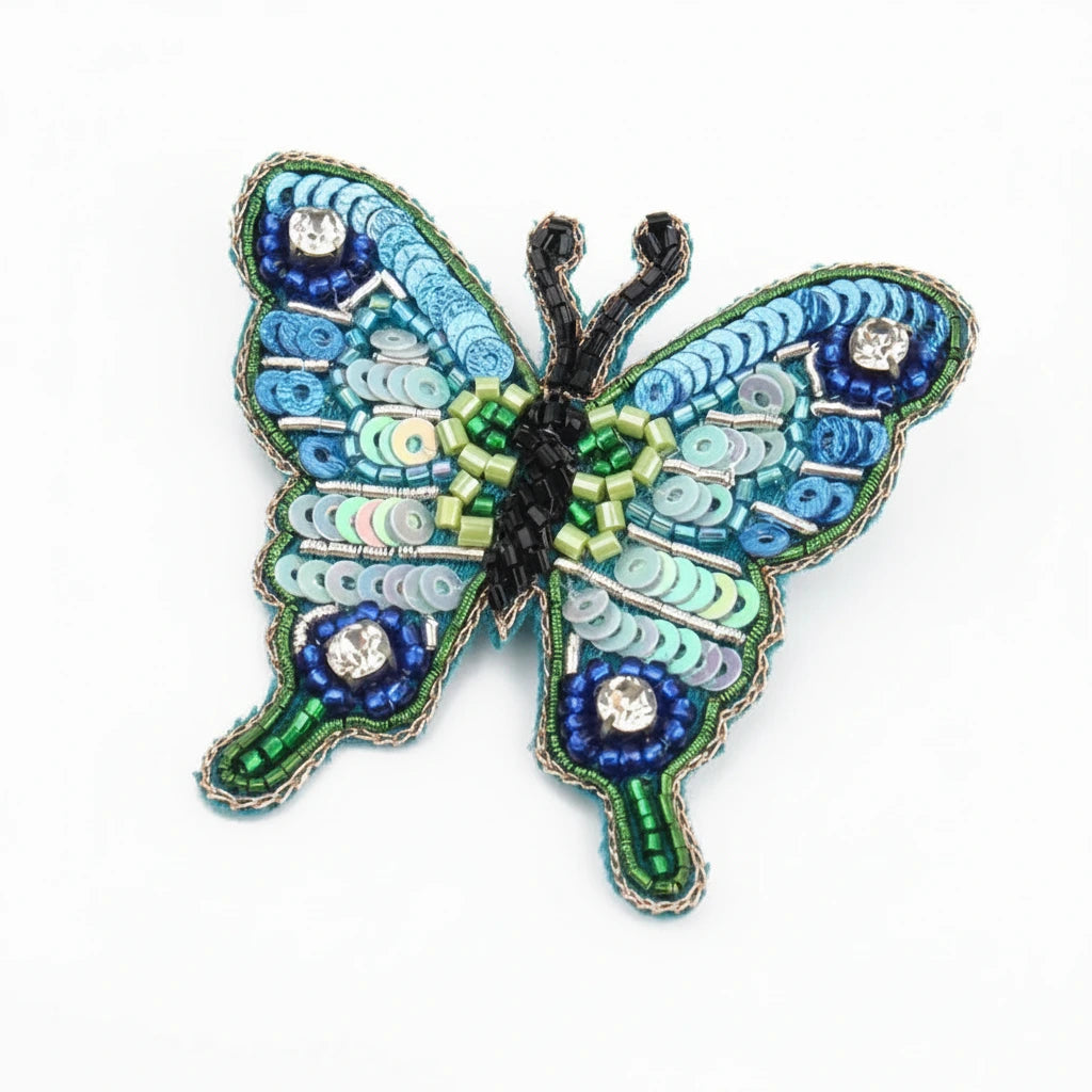 Decorative butterfly with blue and green patterns on a white background